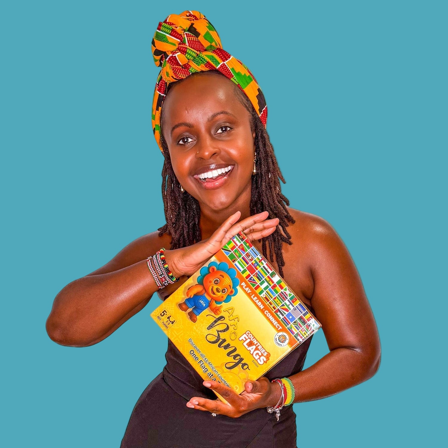 Woman holding a book titled 'Bun' with a colorful cover, wearing a patterned headscarf and bracelets.