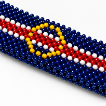 Close-up of handmade Cape Verde beaded bracelet showing yellow stars and detailed blue, white and red beadwork