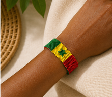 Handmade Senegal flag beaded bracelet worn on wrist in a lifestyle setting